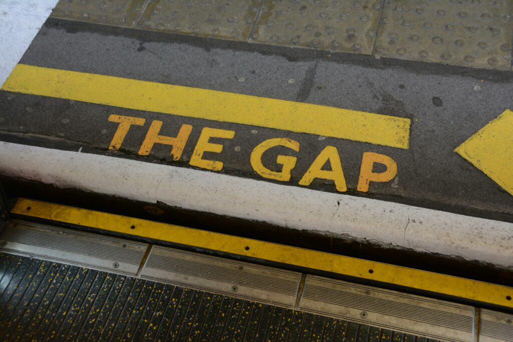A picture of a step from a subway, labeled with the words, “The Gap” in yellow.